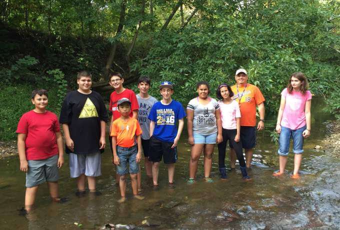 students in creek outdoor adventures summer program