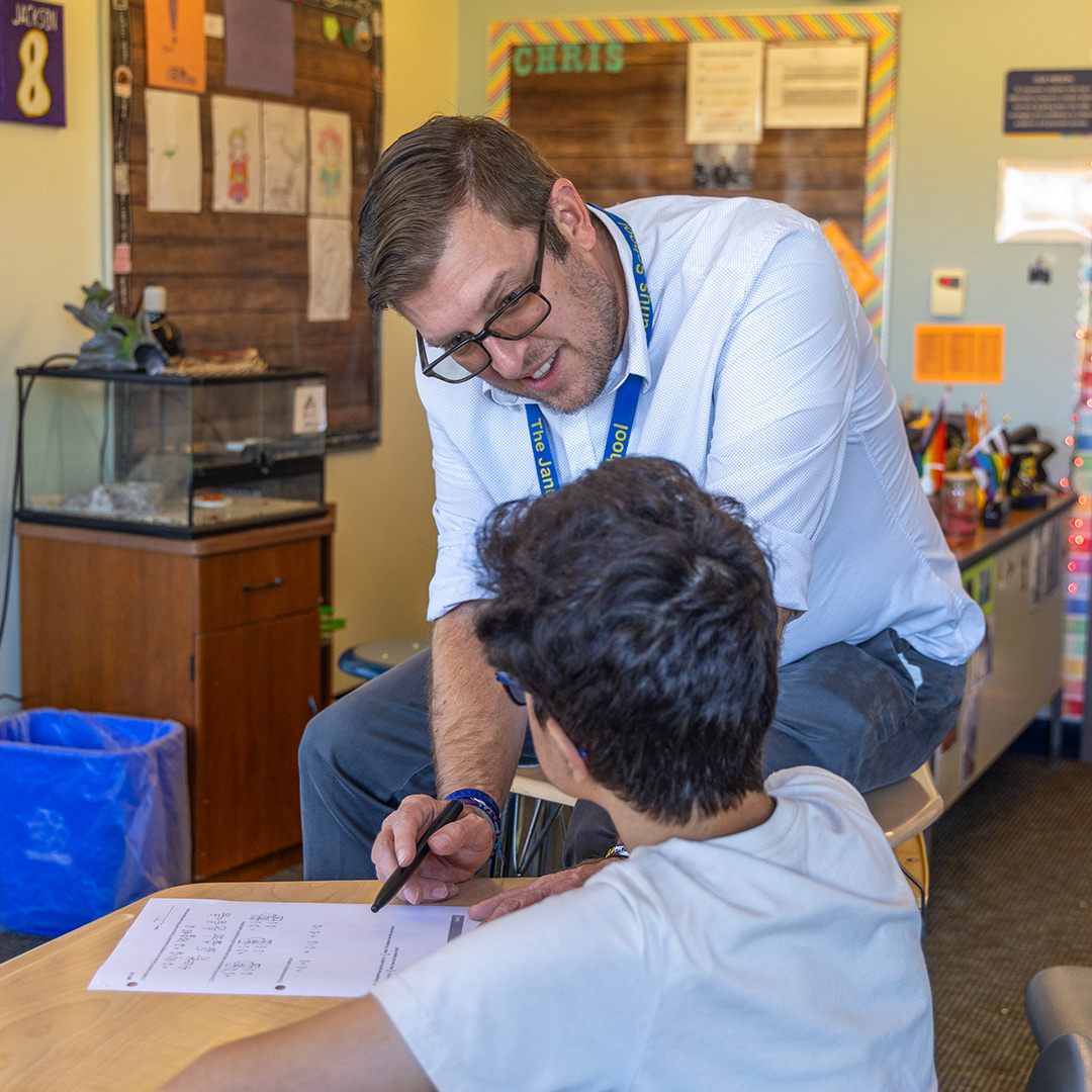 Teacher helping student in classroom