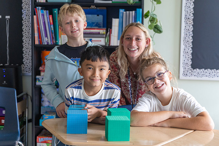 Small group of Janus students and teacher smiling
