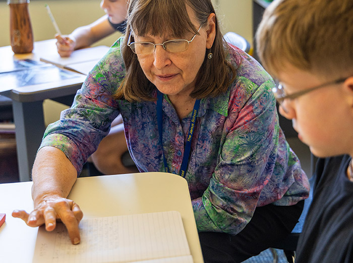 Teacher assisting student