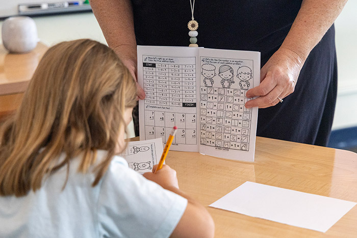 Teacher assisting student